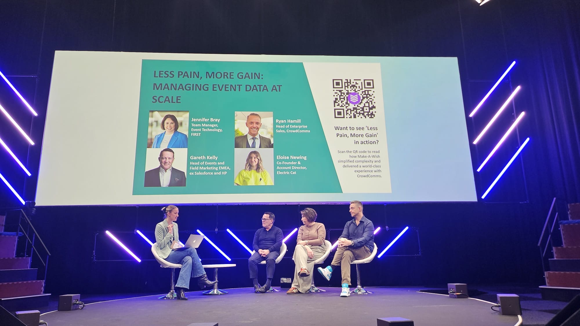 Speaker on stage with SpeakerStacks QR code displayed